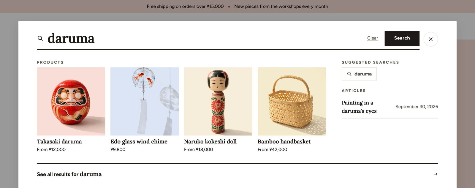 The search panel open over the home page, showing suggestions for “daruma” while typing